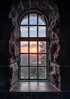 Cosy view looking through an old window with sunset at autumn morning in National Park, Finland