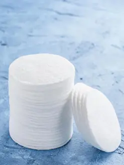 Cleansing Prints: cotton pads on blue concrete background close up