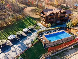 Pergola Prints: Country recreation center located in the woods with a large blue pool