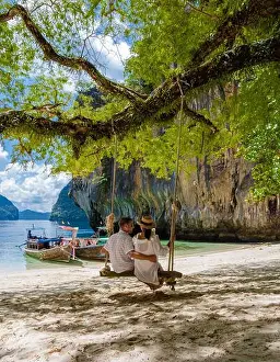 Krabi Prints: Couple on a boat trip to the Tropical lagoon of Koh Loa Lading Krabi Thailand part of the Koh Hong Islands in Thailand