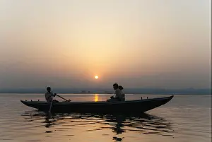 Mornings Prints: Couple on a boat watching the sunrise, Ganges River, Varanasi, India, Asia