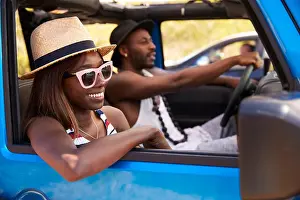 Young Couple Prints: Couple Driving Open Top Car On Country Road