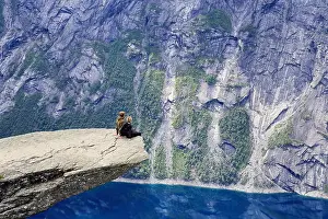 Epic Prints: Couple of hikers enjoying view from Trolltunga rock formation in Norway