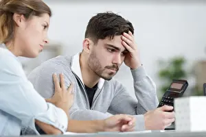 Supportive Prints: couple looking depressed as they do some calculations