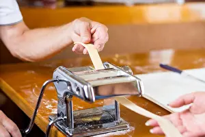 Spinning Prints: Couple making homemade pasta at home with a machine