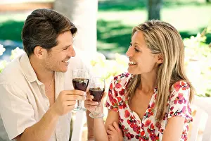 Girlfriend Prints: Couple toasting each other outdoors