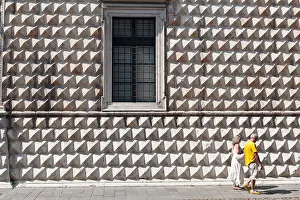 A couple walk by the Palazzo dei Diamanti Ferrara Emilia-Romagna Italy