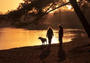 Labrador Prints: Couple walking their dog beside a lake