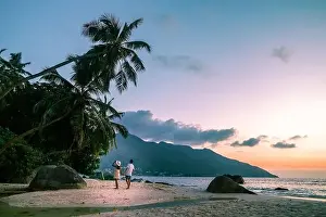 Anse Prints: couple walking on tropical beach Mahe Seychelles during sunset
