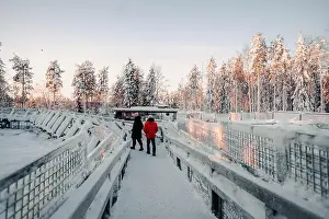 Boreal Prints: Couple walking over wooden footpath next to enclosures in wildlife park, Ranua