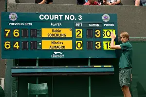 The Court 3 scoreboard is changed during the 2009 Wimbledon Tennis Championships