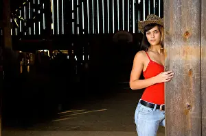 Tank Top Prints: Cowgirl in barn doorway with hat and tank top
