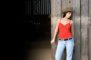 Tank Top Prints: Cowgirl in barn doorway with hat and tank top