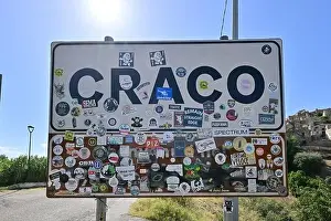 Basilicata Prints: Craco, Italy - Aug 6, 2023: Sign at the entrance of the abandoned village of Craco