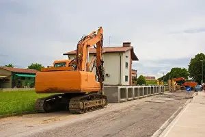 Friuli Venezia Giulia Prints: A crawler excavator with rotating house platform & continuous caterpillar track with reinforced concrete box culverts