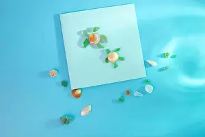 Memento Prints: Creative representation of turtle crafted from seashells and glass fragments on blue sea-like background