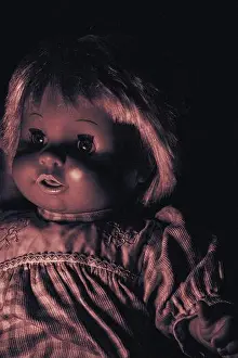 Alive Prints: Creepy doll on a dark background. Halloween background