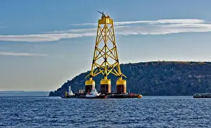 Turbine Prints: Cromarty Firth Nigg Scotland the yellow jacket base of an offshore wind turbine being towed past the Cromarty Sutor