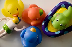 Fun Kids Prints: Crop of children's bath toys including colored rubber ducks and a wind up swimming man