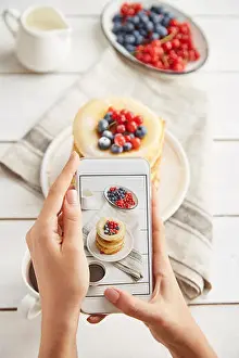 Coffee Cup Prints: Cropped hands of woman photographing breakfast served on wooden table at home