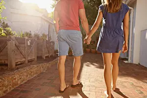 Heterosexual Prints: Cropped shot of young couple walking towards their house together