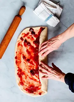 Braided Prints: From above cropped unrecognizable person hands making fresh strawberry brioche on a kitchen white modern marble table