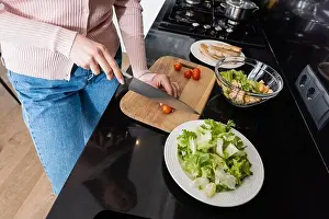 Partial Prints: cropped view of woman cutting cherry tomatoes near fried chicken fillet while preparing breakfast
