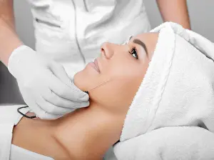 Only Women Prints: cropped woman face getting facelift, procedure lifting skin