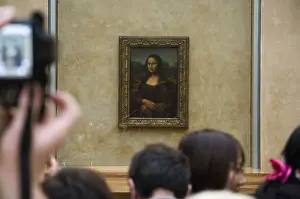 Admiring Prints: Crowd of visitors admiring and photographing the Mona Lisa at the Louvre