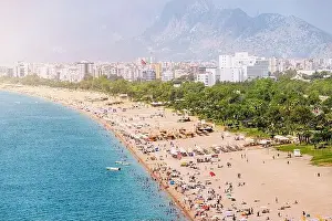 Sunburn Prints: Crowded Antalya city Konyaalti beach with hundreds of vacationers and tourists resting
