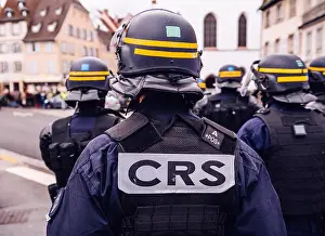 Vest Prints: CRS police officers securing the zone in frong of the Yellow vests movement protesters on Quai des Bateliers street