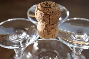 Goblet Prints: detail of some crystal glasses with champagne cork and Its light reflections