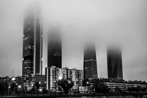 Early Morning Prints: The Cuatro Torres Business Area with the four towers surrounded by fog in the morning as seen from Chamartin railway