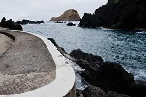 Beach Landscape Prints: Curved concrete walkway leads to the rocky coastline and serene waters at Porto Moniz natural pools