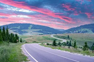 Curvy mountain road serpentine in summer mountains during sunset. Ukraine, Carpathian mountains. Landscape photography