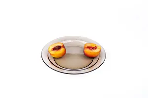 Peach Prints: two cut nectarines on a plate, isolated