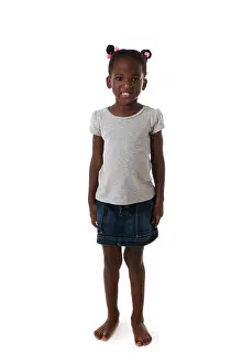 African Ethnicity Prints: Cute African little girl standing barefoot, looking to the camera on white background