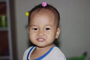 Earrings Prints: A cute beautiful Indonesian baby girl playing in the house