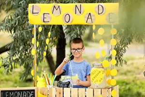 Earn Prints: Cute boy selling lemonade in park