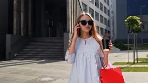Shopper Prints: Cute girl in dress walking in front of the shopping mall with shopping bags