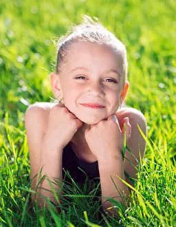 Young Summer Prints: cute happy little girl lying on the grass