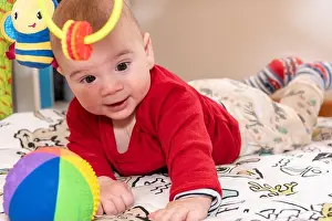 Playtime Prints: Cute little baby boy during tummy time looking at camera