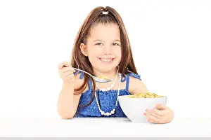 Muesli Prints: Cute little girl eating cereal from a bowl