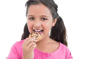 Curly Hair Prints: Cute little girl eating a cookie on white background