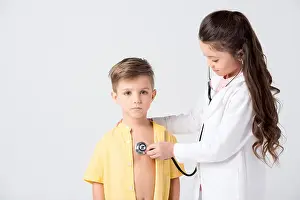 Pediatrician Prints: Cute little kids playing doctor and patient with stethoscope