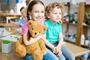 Embracing Prints: Cute Little Kids with Teddy Bear