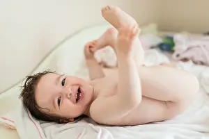 Bathe Prints: Cute nude baby girl lying down after shower