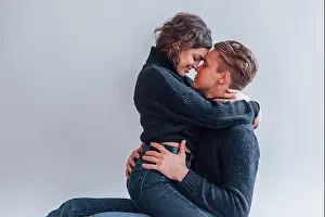 Closeness Prints: Cute young couple embracing each other indoors in the studio