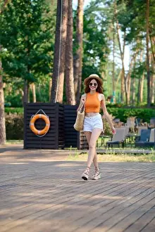 Long Haired Prints: Cute young woman in orange top and white shorts