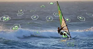 Gliding Prints: Cutting windsurfer in black wetsuit skimming sailboard on swells near sunset